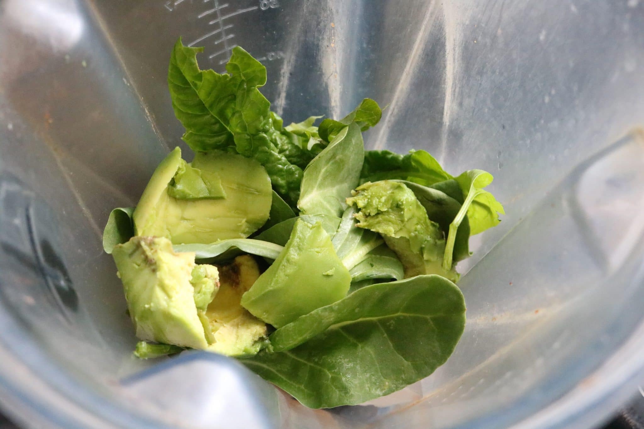 Spinach, avocado and seeds in a blender