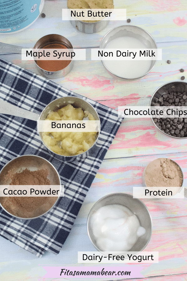 Multiple ingredients like mashed banana, protein powder, and yogurt for gluten-free brownies in measuring cups, all ingredients labeled.