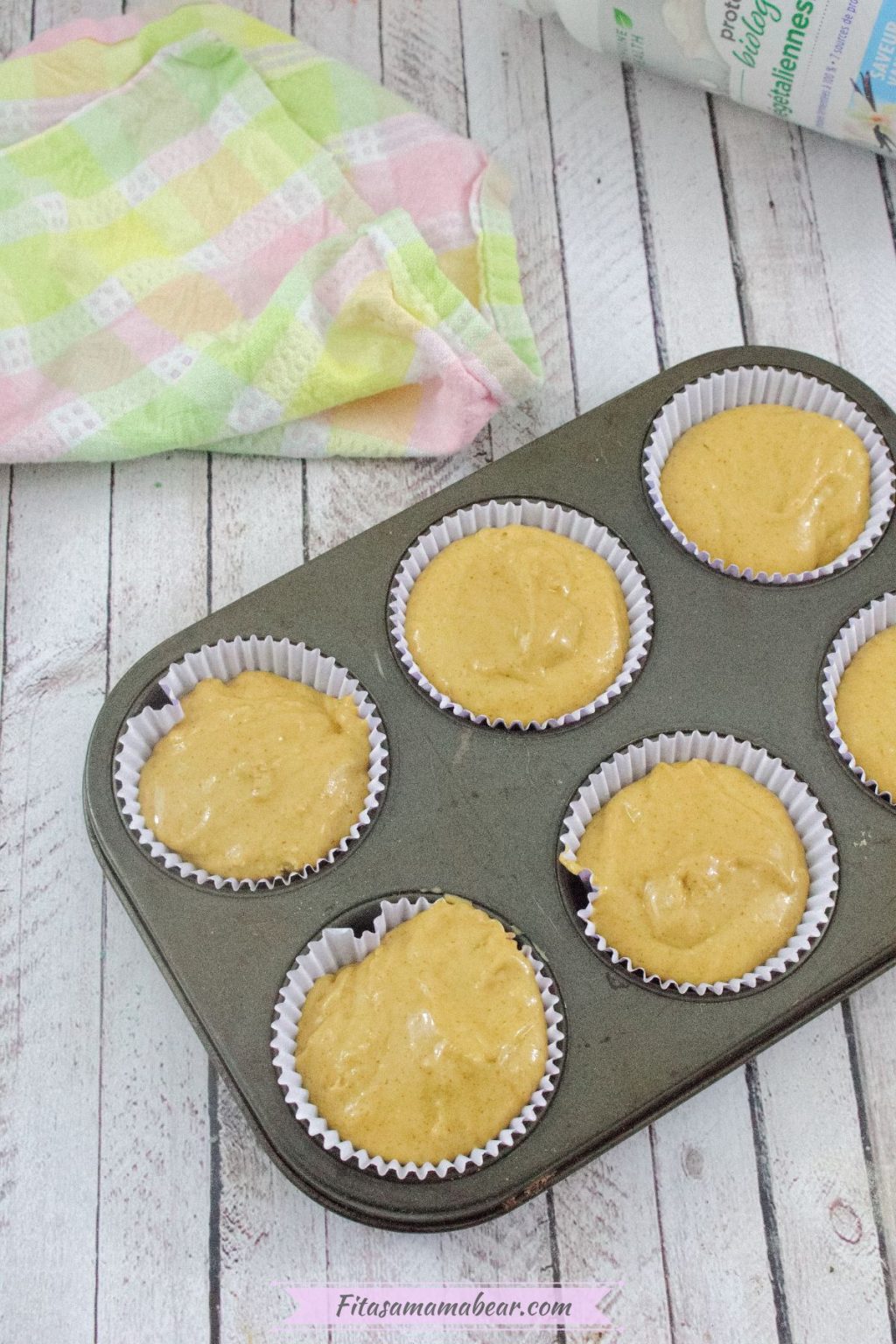 Raw protein muffins in muffin liners in a baking tray