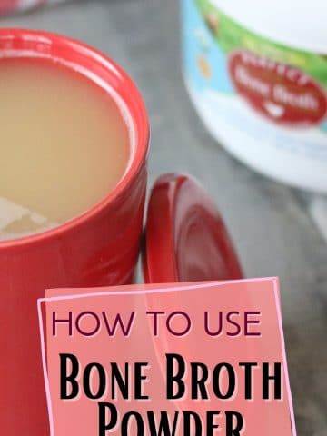 Pin image with text: red tea mug with bone broth in it and a tub of bone broth powder behind it