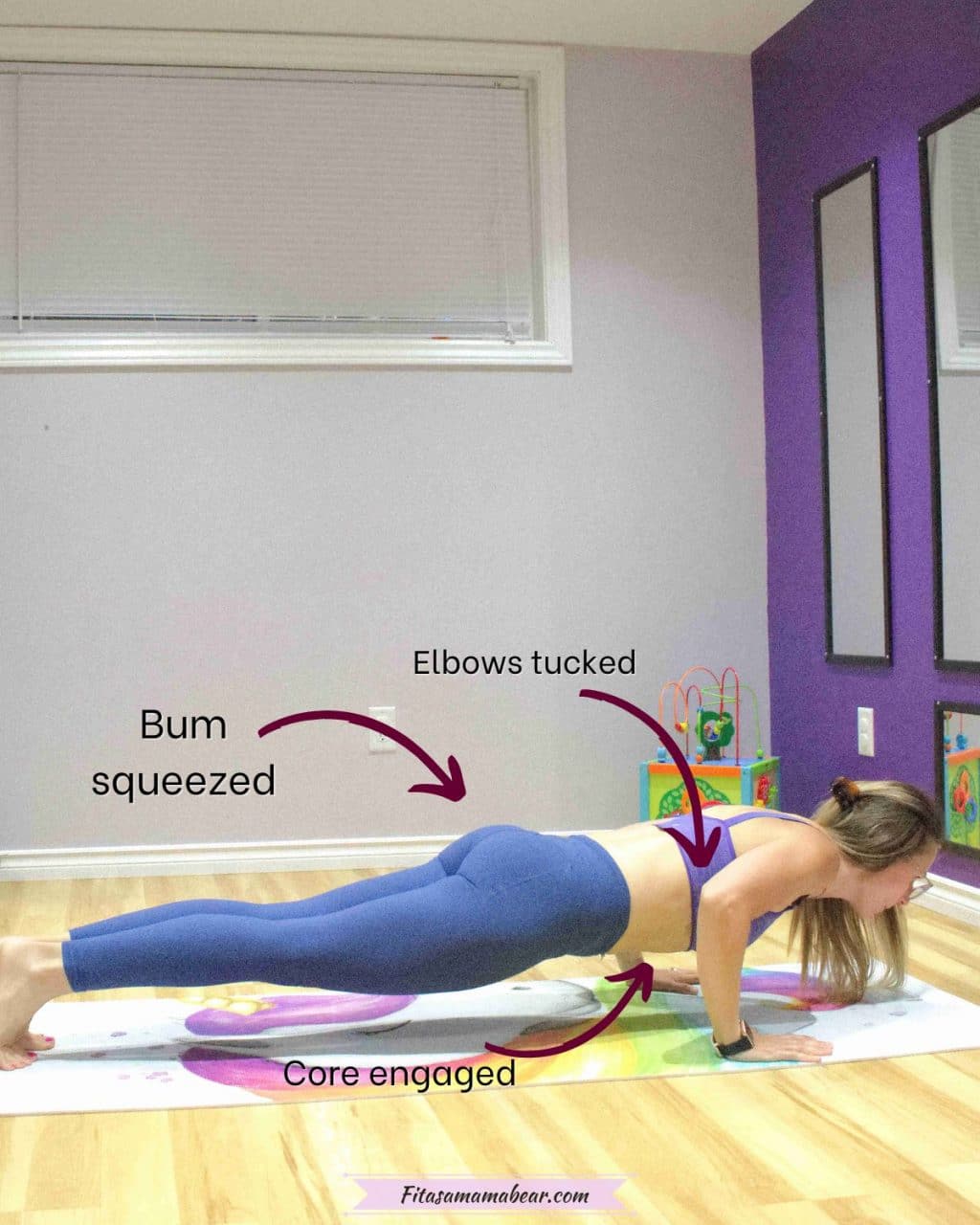 woman in blue pants and purple sports bra in a bottom push up position on a yoga mat with arrows and text about how to perform the exercise