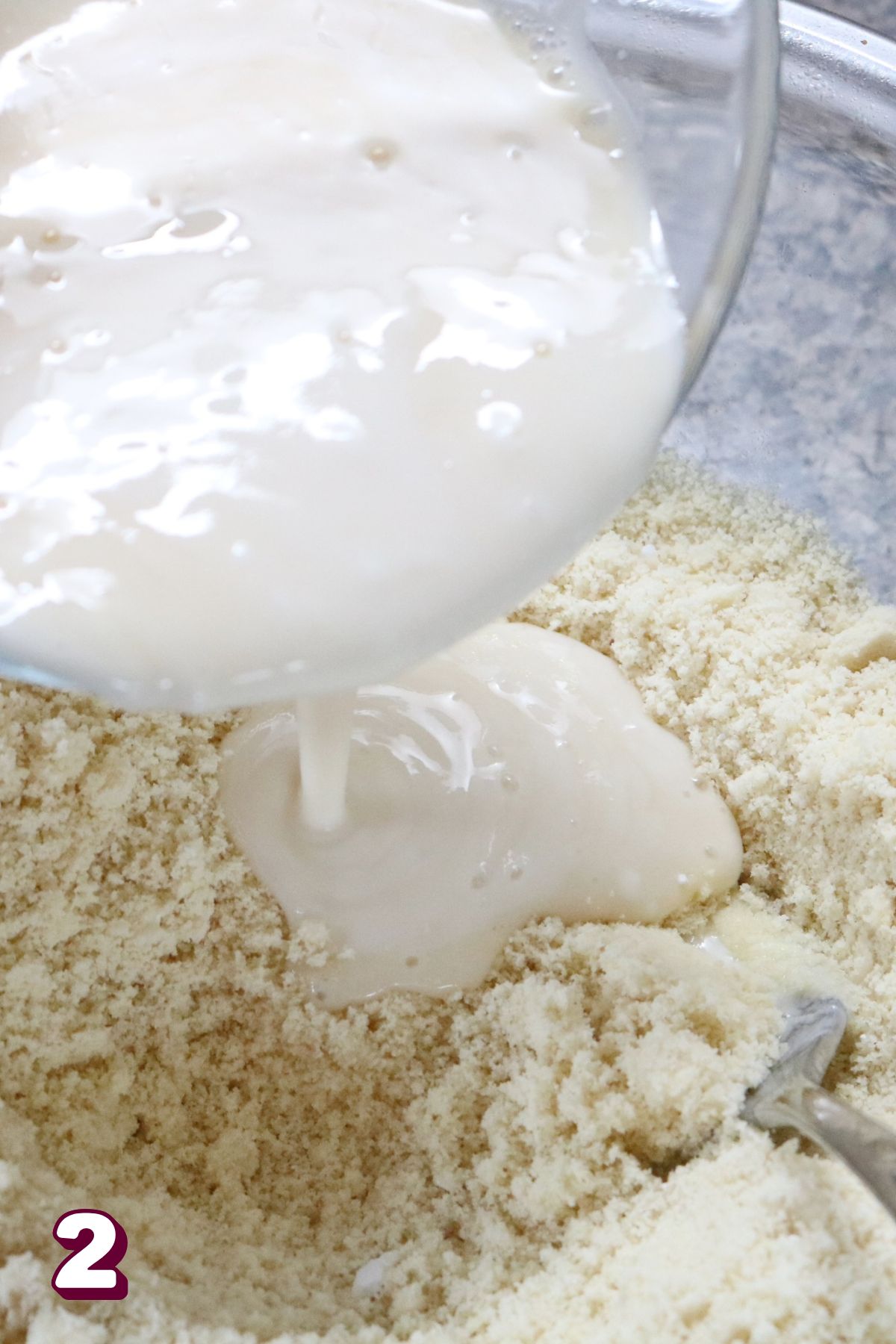 Inprocess image for yogurt pancakes. Pouring wet ingredients into dry