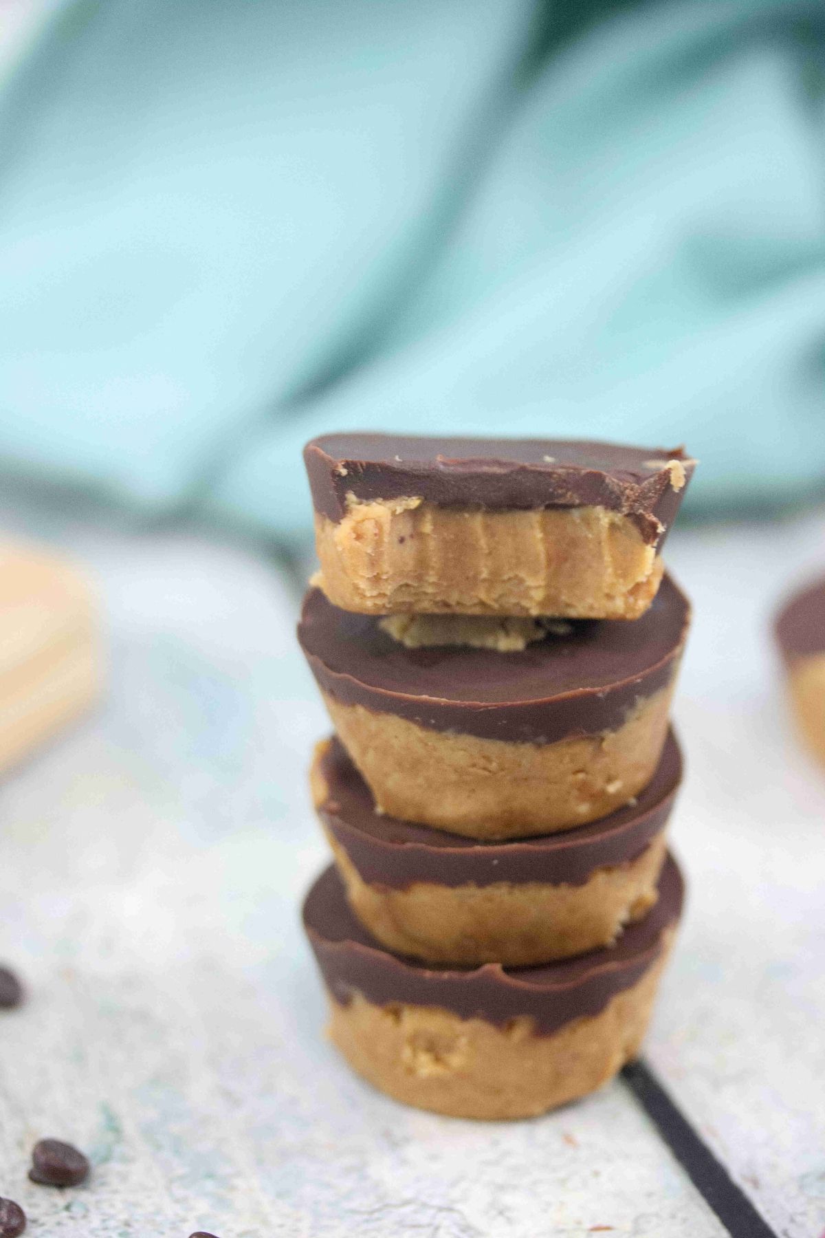 Four chocolate peanut butter protein cups stacked.
