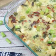 Dairy-free chicken alfredo casserole in a clear casserole dish with green onions on top