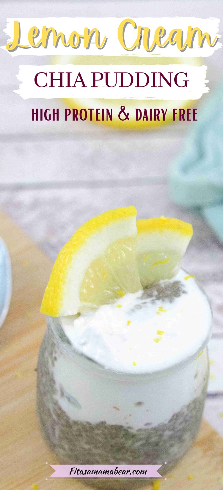 Lemon chia protein pudding topped with coconut cream in a small jar with lemons on top and the jar on a wooden cutting board.