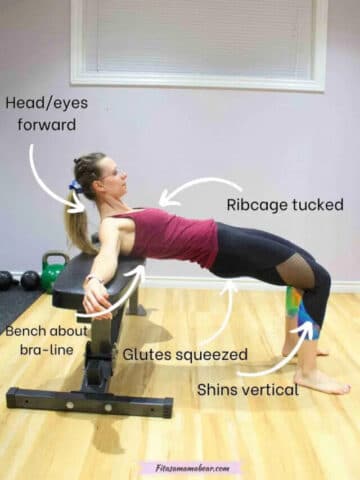 Woman in pink shirt and dark pants performing a glute bridge in a bench with multiple arrows and text showing the key technique points to perform the exercise