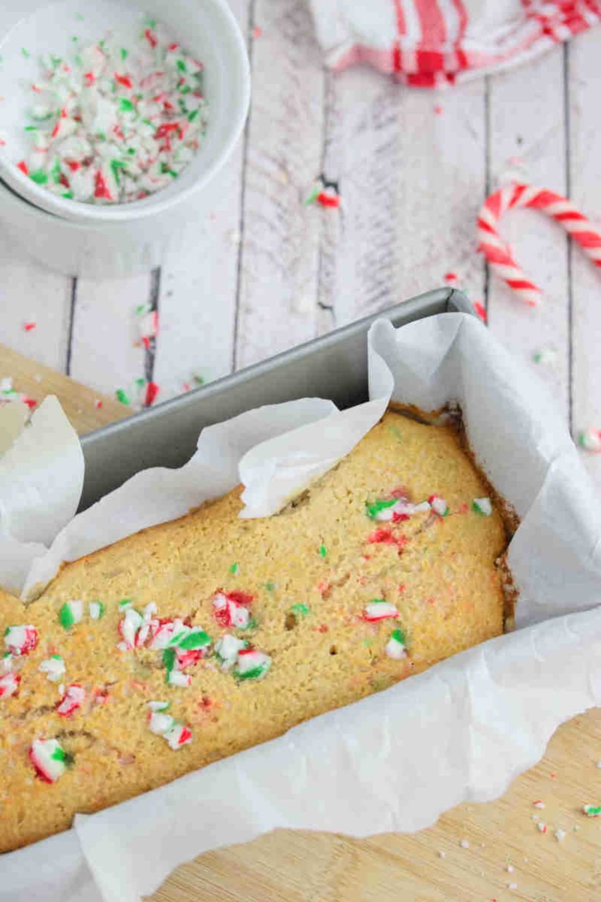 Candy cane baked oatmeal in a baking loaf lined with parchment paper.