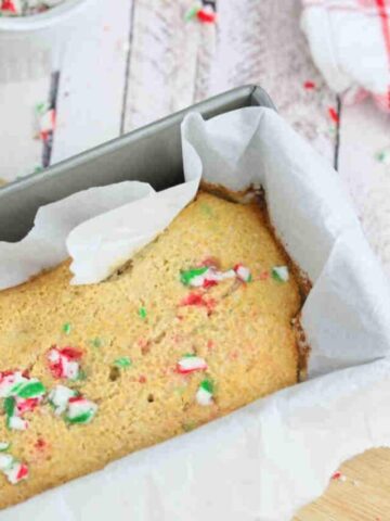 Candy cane baked oatmeal in a baking loaf lined with parchment paper.