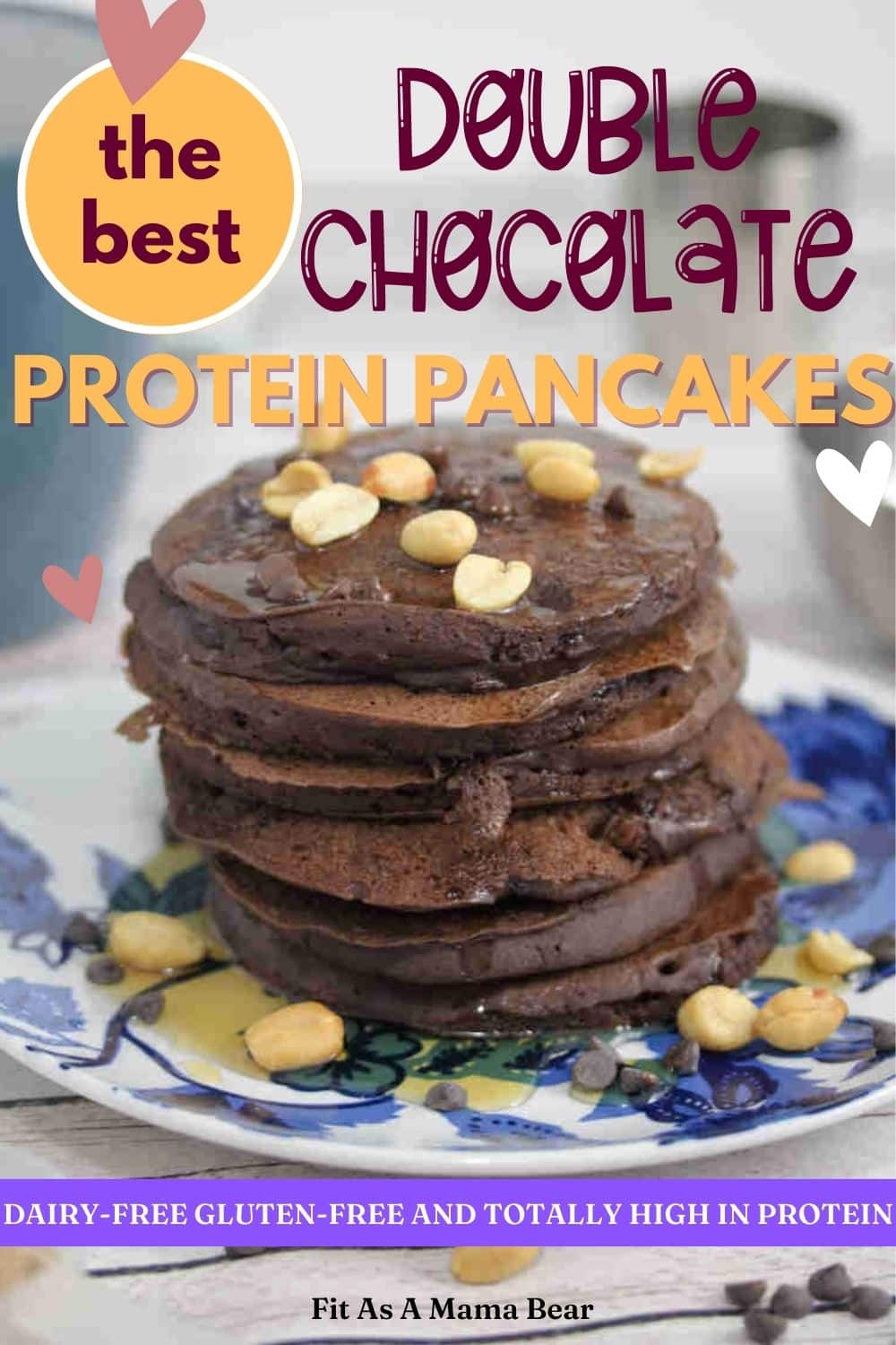 Blue and white plate with chocolate protein pancakes topped with peanuts with a coffee mug and silver bowl behind them and text on top of the image.