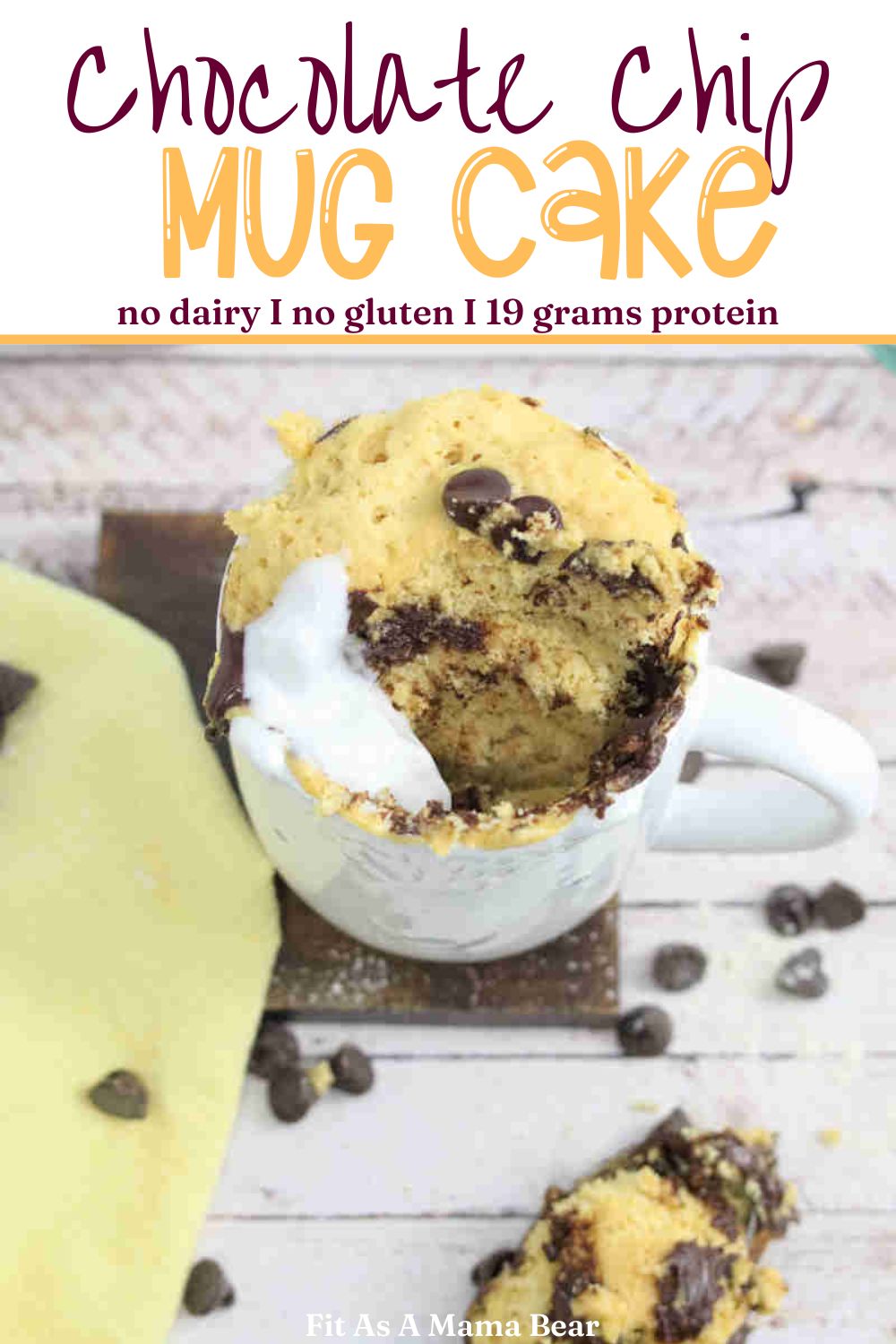 Chocolate chip mug cake with coconut cream in a white mug on a dark coasted with a yellow linen by it and text on the image.