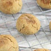 Close up of dairy-free protein cookies with cinnamon sugar on a cooling rack.