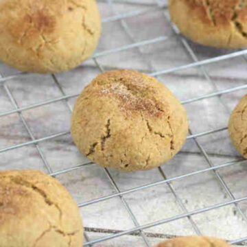 Close up of dairy-free protein cookies with cinnamon sugar on a cooling rack.