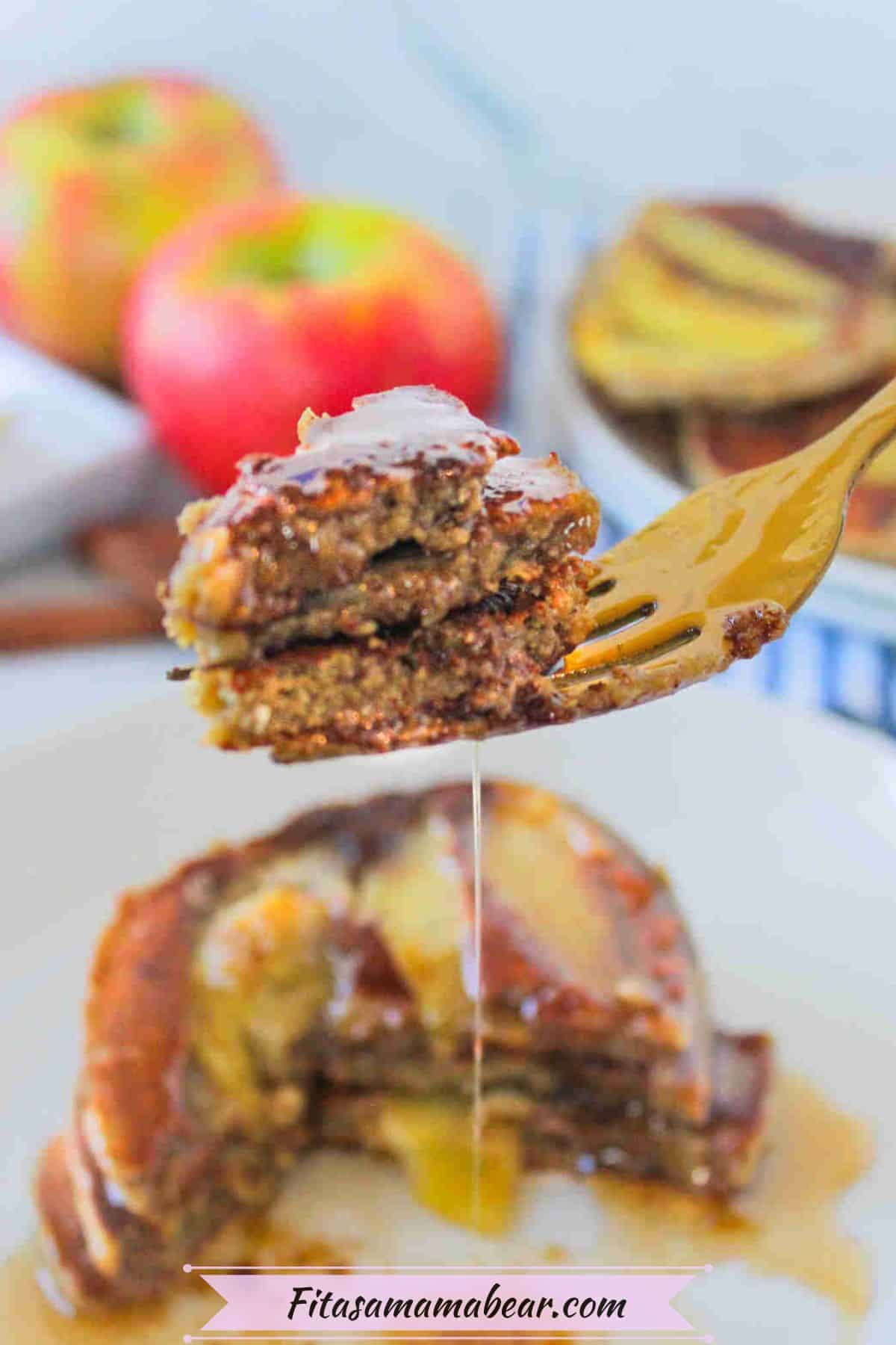 Fork of sliced pancakes dripping in syrup.