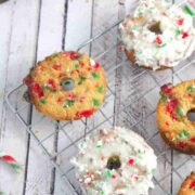 Candy cane donuts on a cooling rack some donuts frosted with glaze.