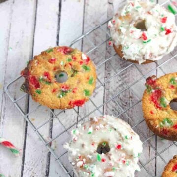 Candy cane donuts on a cooling rack some donuts frosted with glaze.