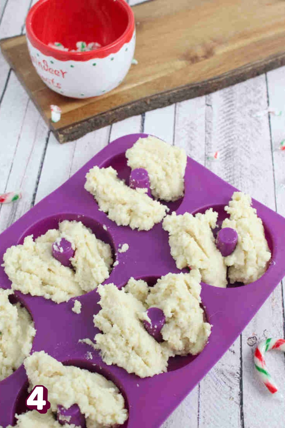 Raw donut batter in a purple mold.