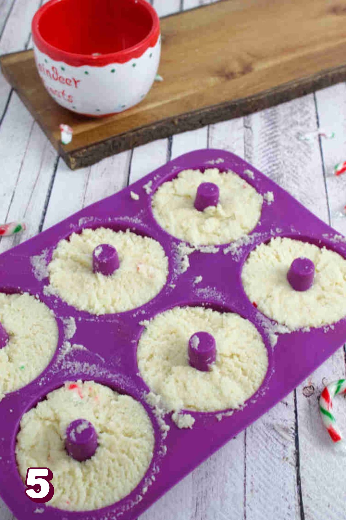 Raw donut batter in a purple mold.
