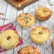 Candy cane donuts on a cooling rack.