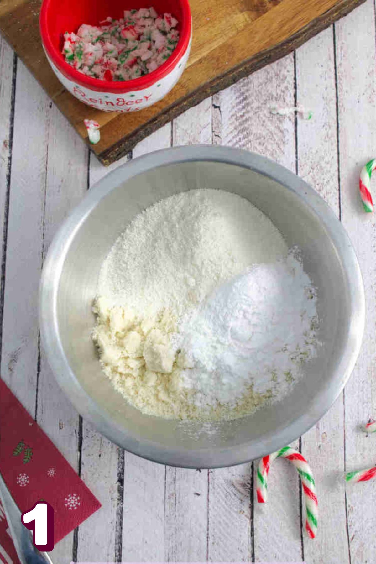 Multiple paleo flours in a steel bowl with candy canes around it.