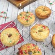 Candy cane donuts on a cooling rack.