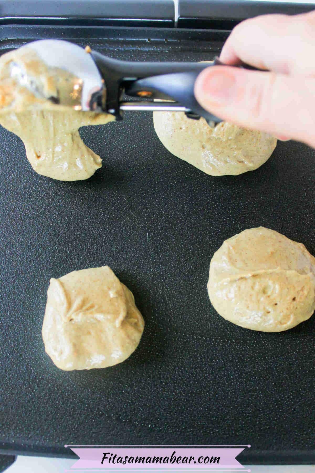 Protein pancake batter being scooped on a greased pan.