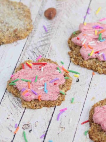 Sugar cookies with pink icing and sprinkles.