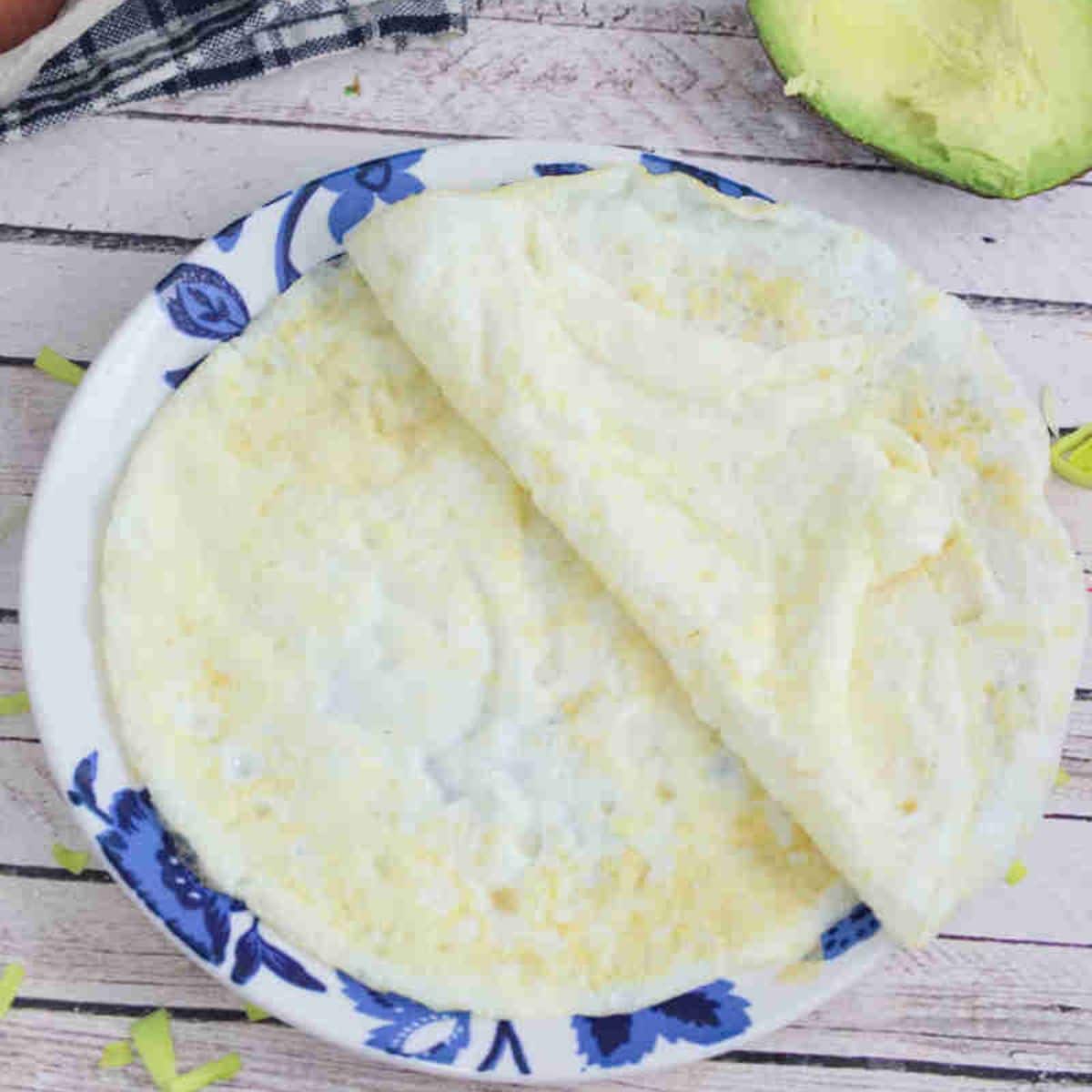 Egg white wraps on a blue flowered plate.