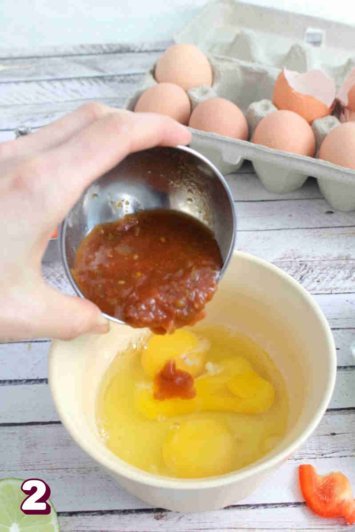 Salsa being poured into a bowl f three eggs.