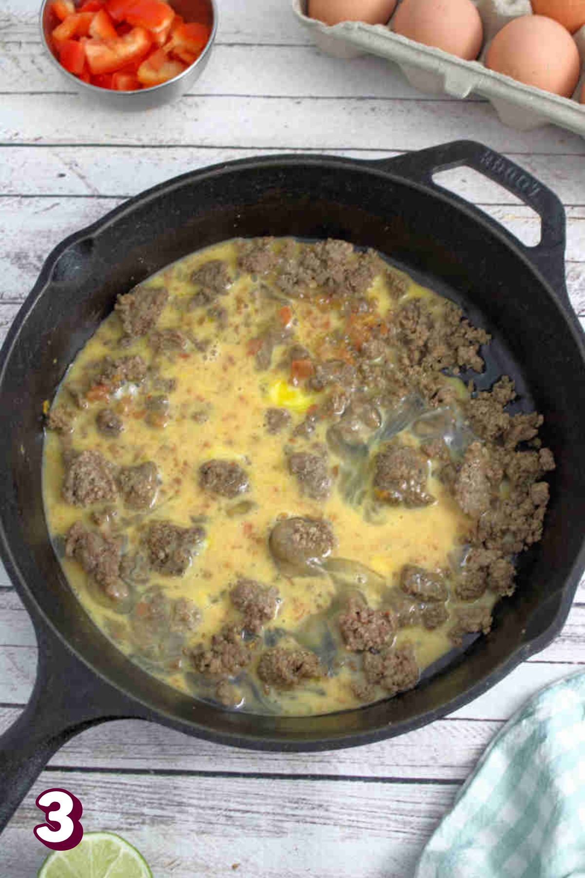 Beef and scrambled eggs in a black skillet