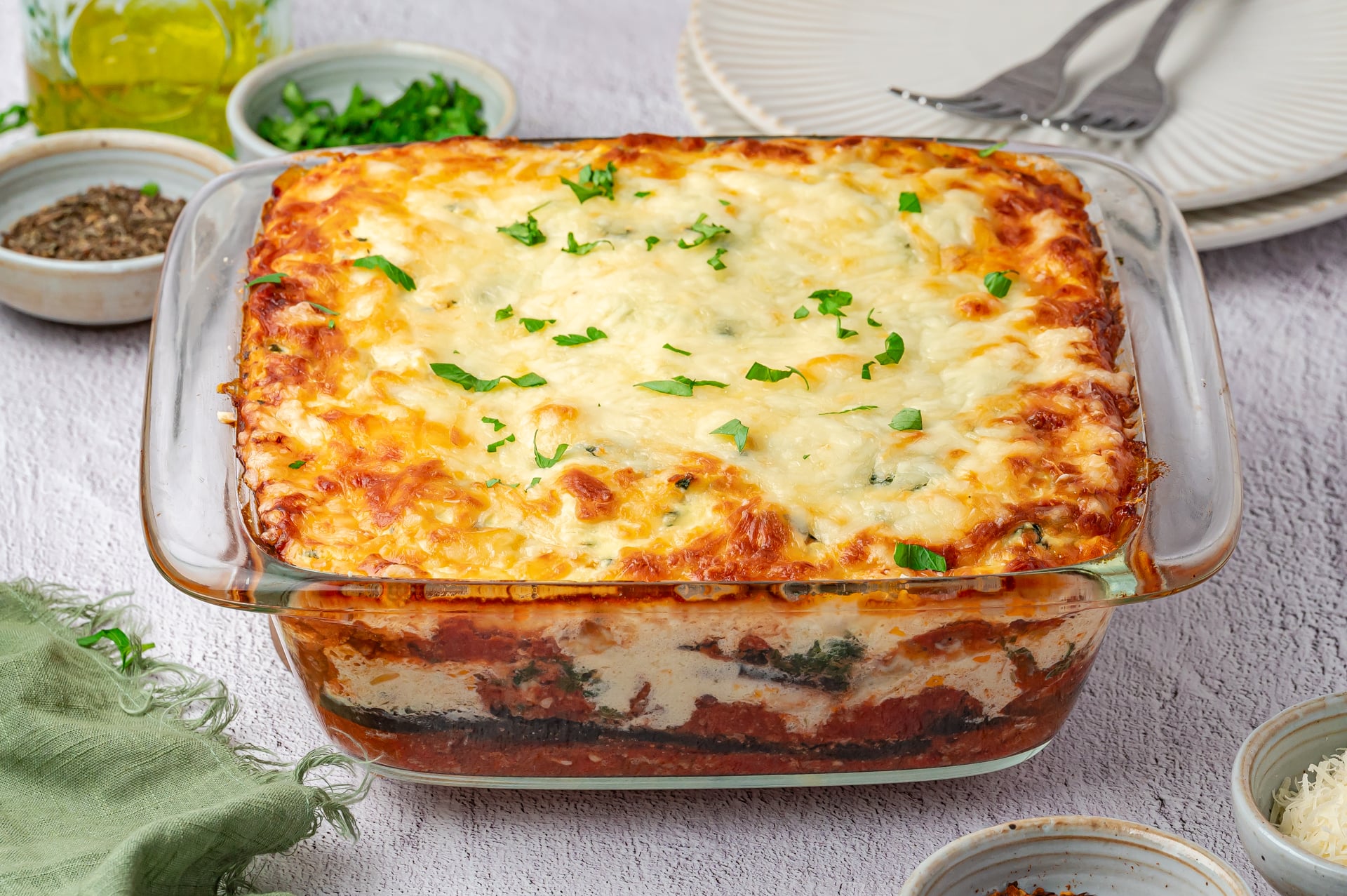 High-protein eggplant lasagna with melted cheese on top in a casserole dish.