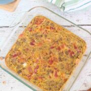 Carnivore casserole topped with bacon in a glass serving dish.