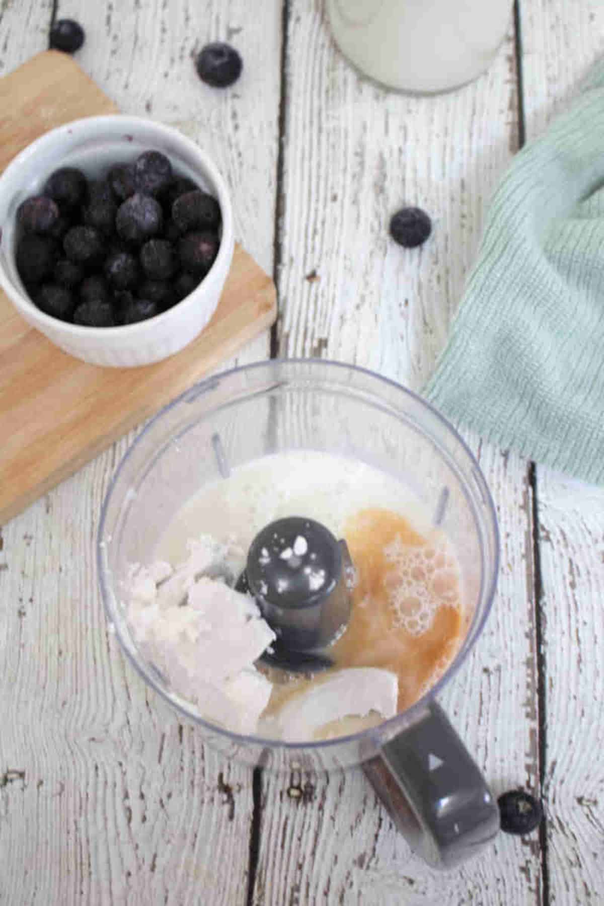 Mini blender with liquid ingredients in it.