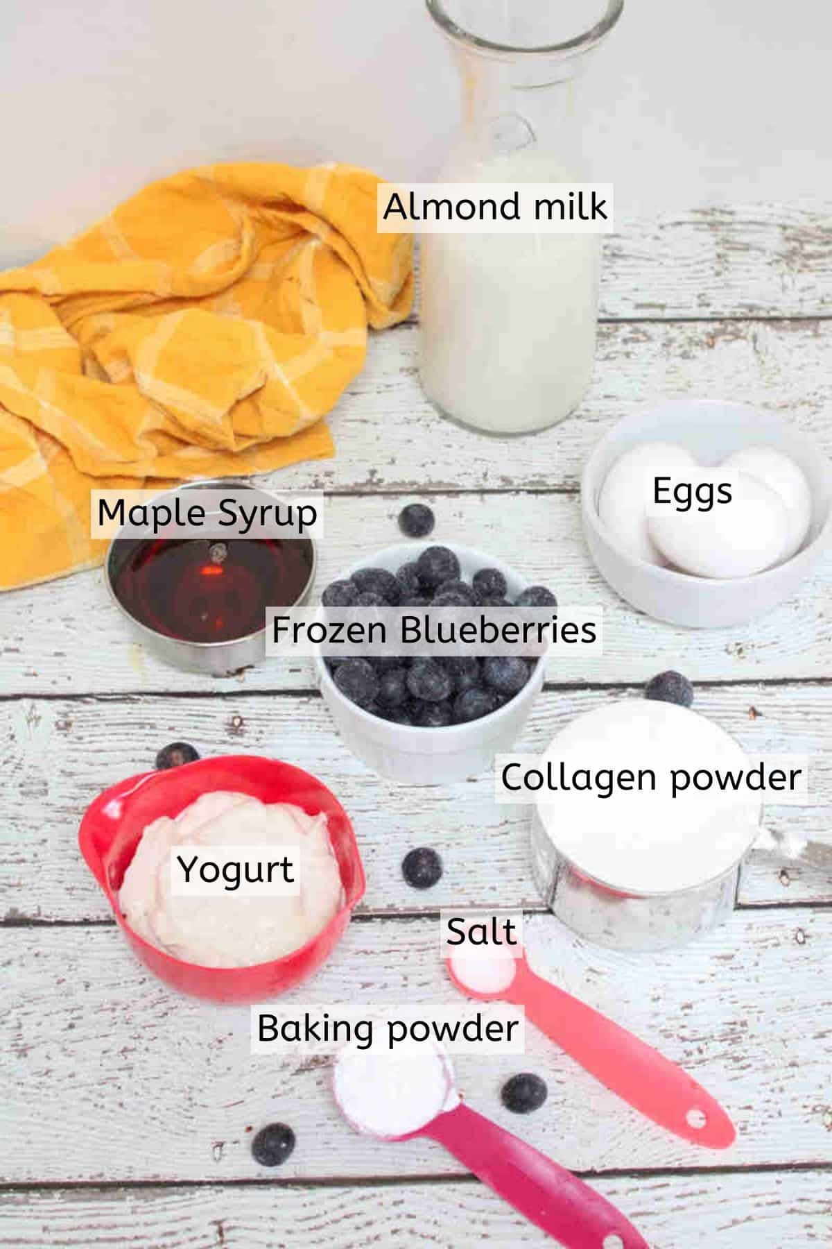 Multiple ingredients to make pancakes in measuring cups with text labels over top.