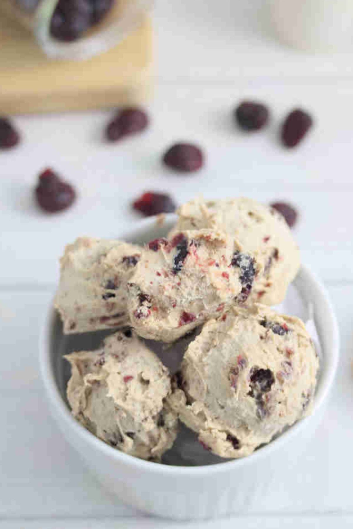Protein balls with cranberries in a white bowl.
