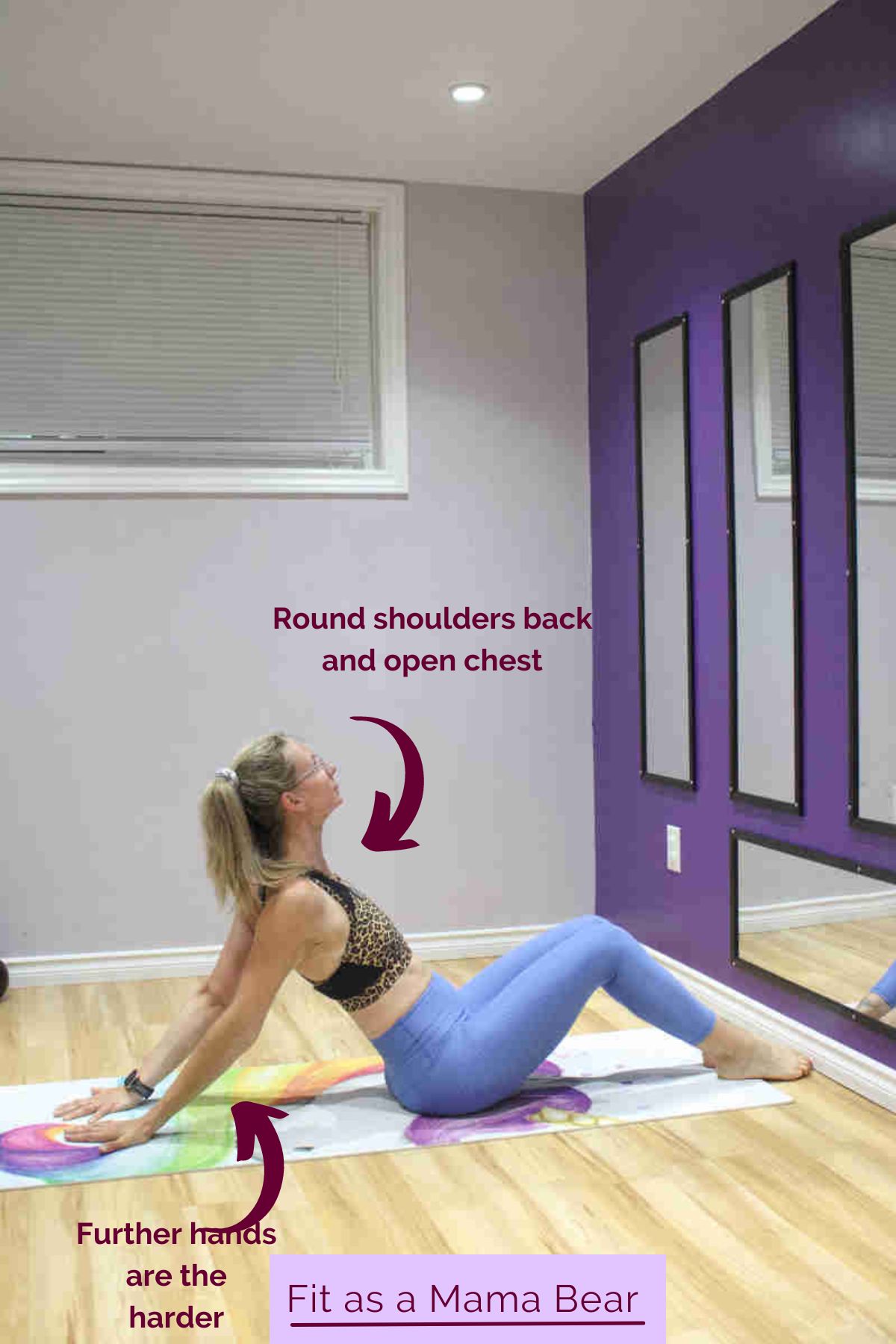Woman in blue pants and sporta bra performing a chest stretch on the ground.
