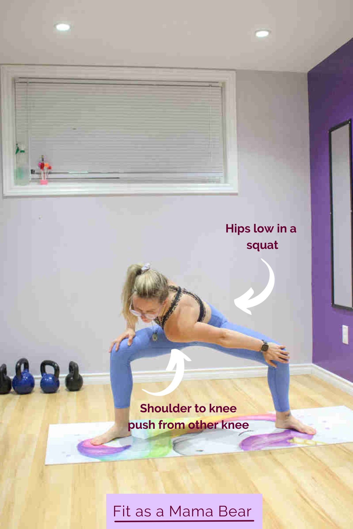 A woman in blue pants and sports bra performing a squat with a rotation.
