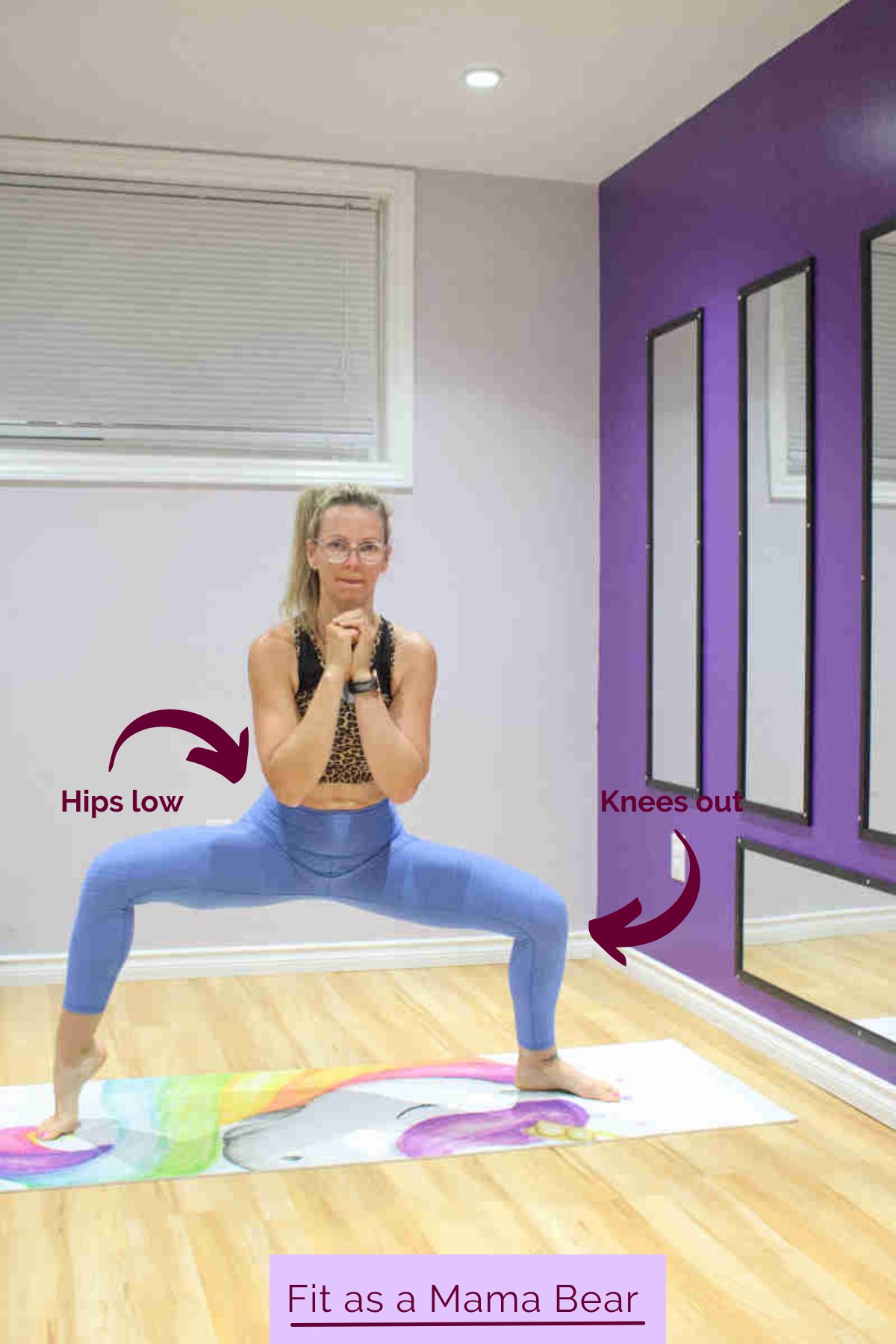A woman in blue pants and sports bra performing a squat with one calf raised.