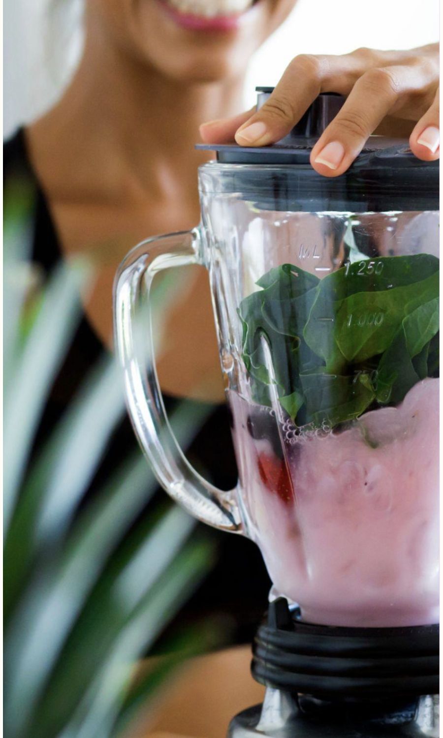Woman blending smoothie.