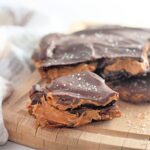Peanut butter chocolate date bark on top of a wooden board.