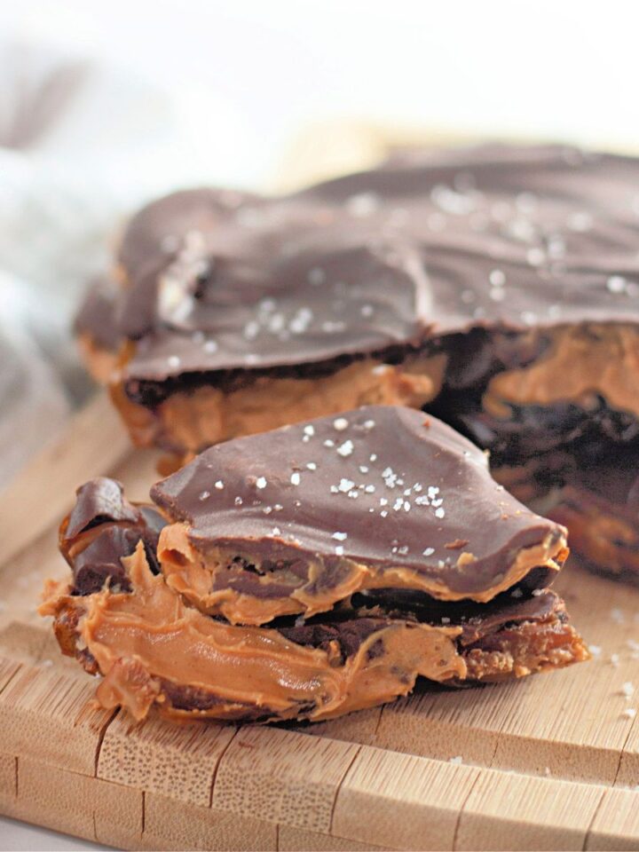 Peanut butter chocolate date bark on top of a wooden board.