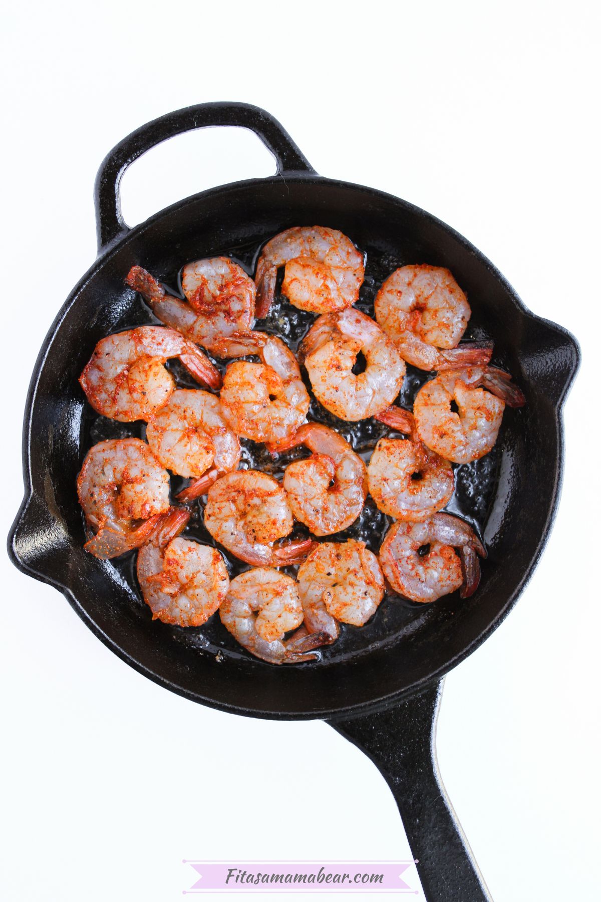 seasoned shrimp seard in a skillet pan
