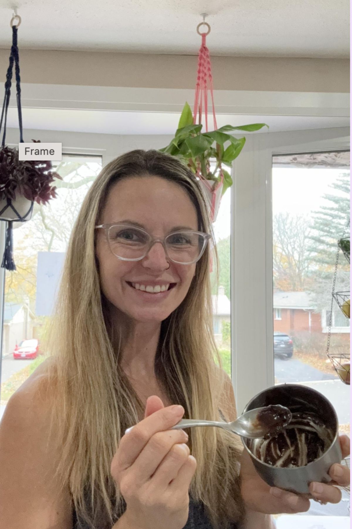 Mom holding a bowl of chocolate and smiling.