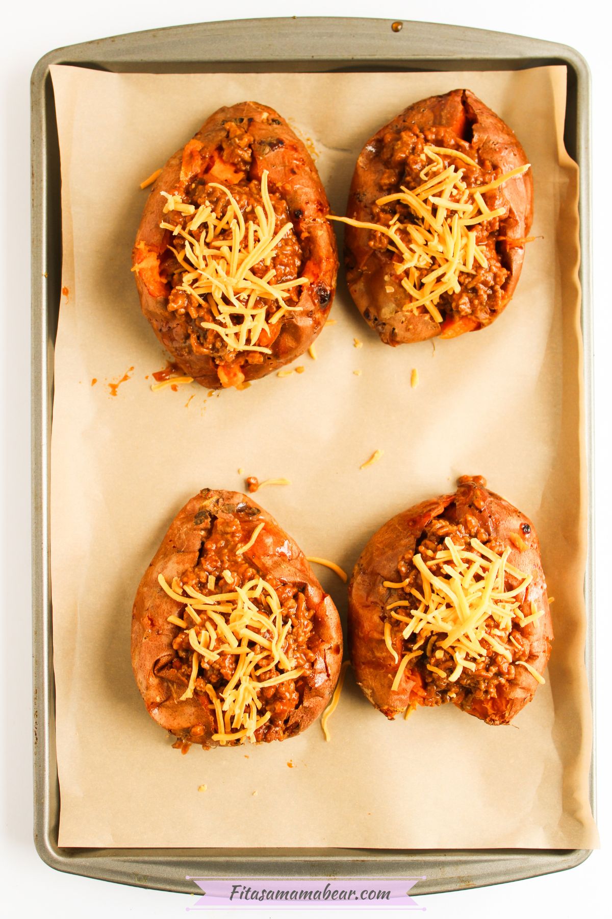 Sliced sweet potatoes with sloppy joe mixture topped with cheese.