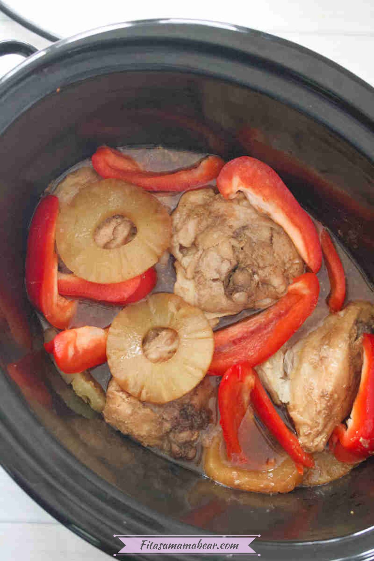 Hawaiian chicken in the slow cooker with sliced bell peppers.