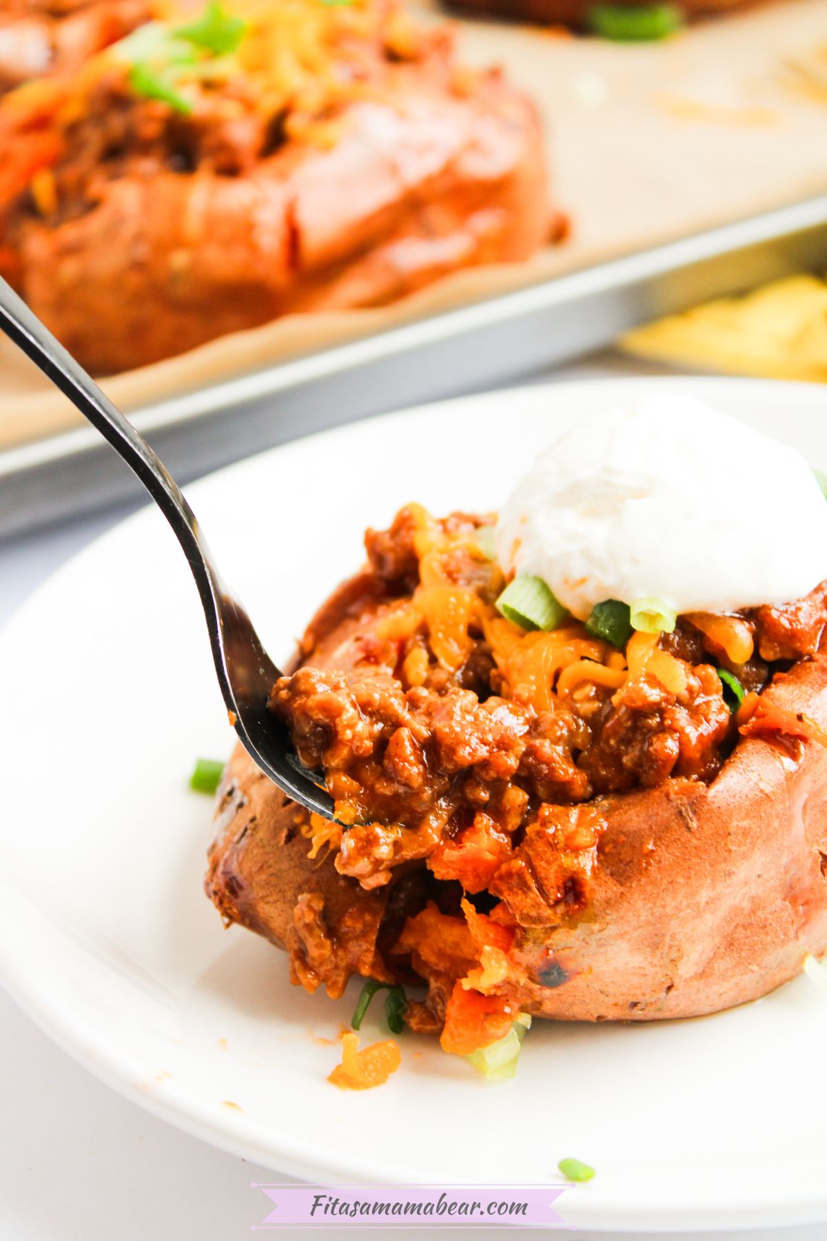 A spoonful of baked sloppy joe sweet potato.
