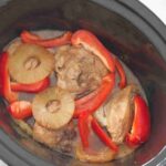 Slow cooker Hawaiian chicken with peppers and pineapples in a crockpot.