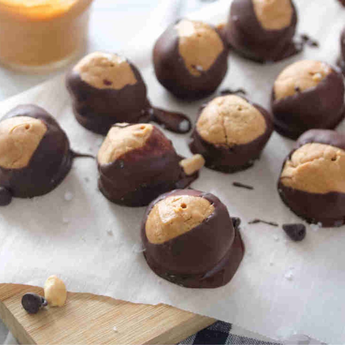 Peanut butter chocolate buckeyes on top of a parchment paper.
