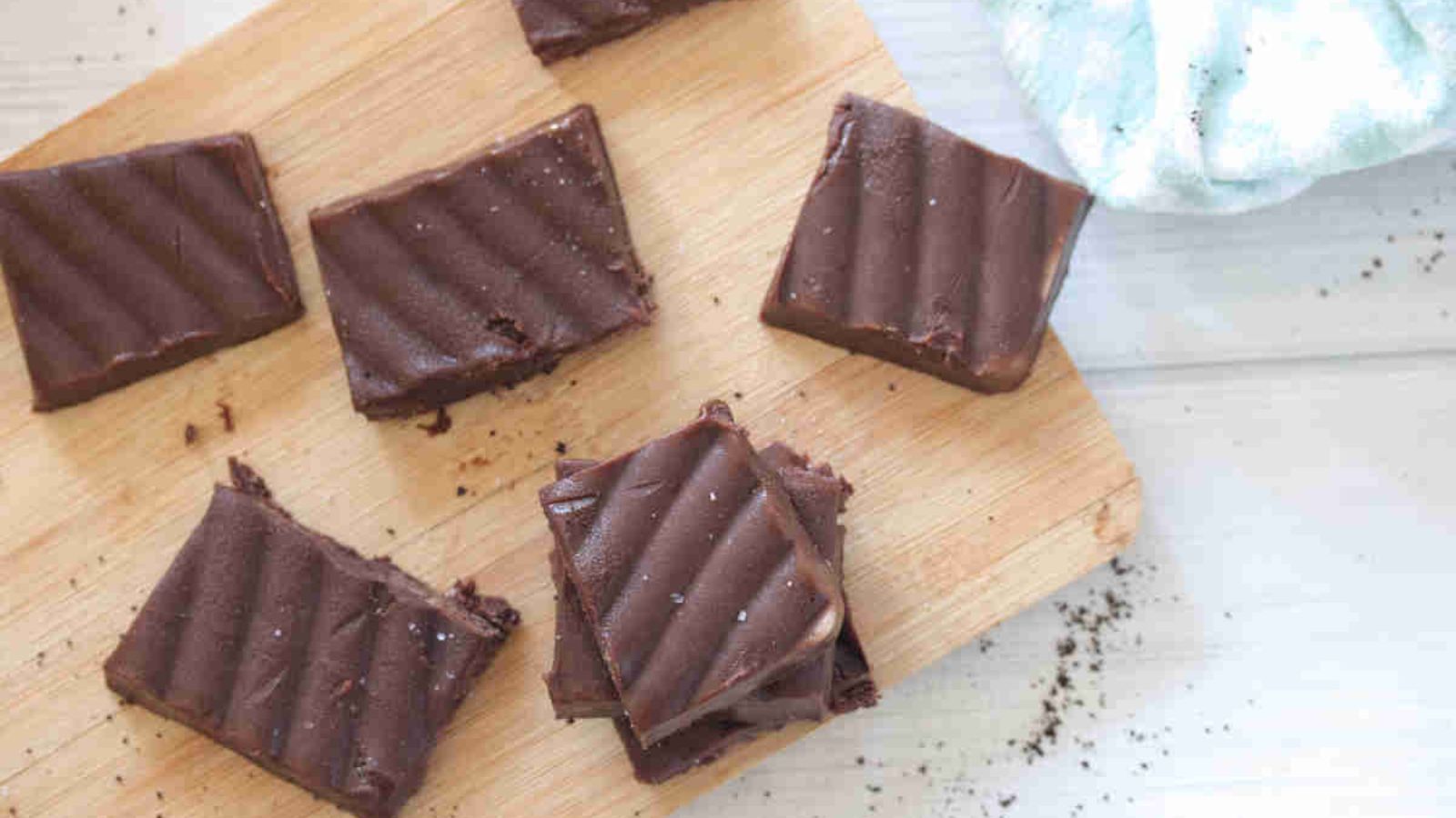 Squares of coffee fudge on a cutting board.