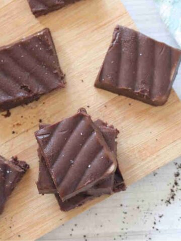 Squares of coffee fudge on a cutting board.