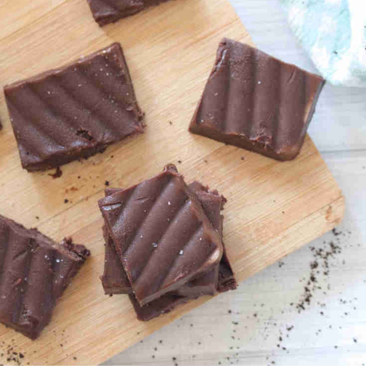 Squares of coffee fudge on a cutting board.